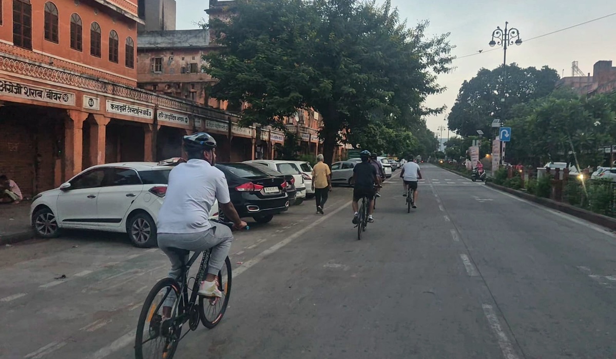 Cyclists riding through Jaipur's historic streets